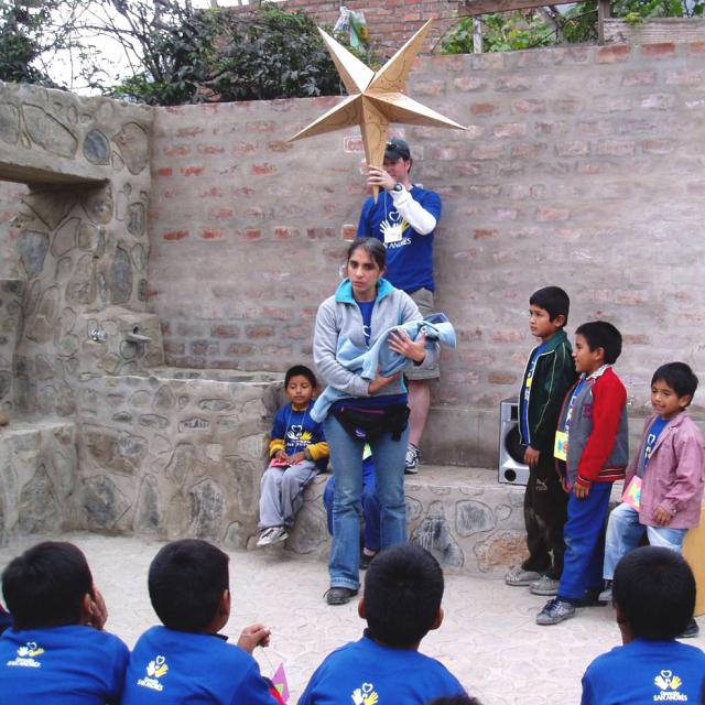 Children listen to the Christmas story in Collique, Peru