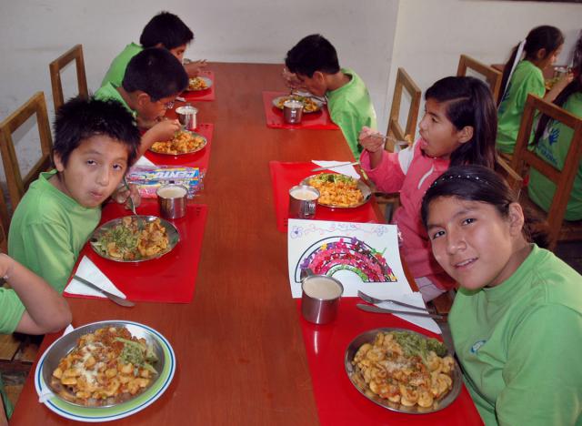 Children eat a nutritious meal in Collique, Peru