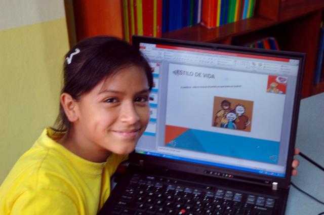 Young girl with donated laptop computer in Collique, Peru